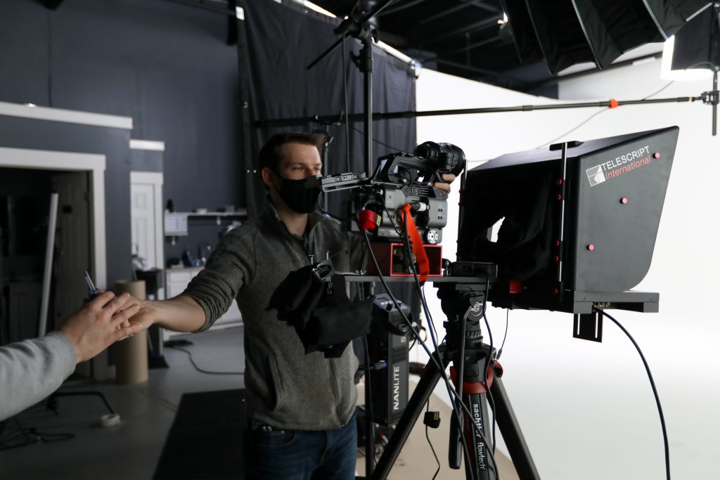 Cameraman shooting inside a studio following a video script - Legion Films Sacramento