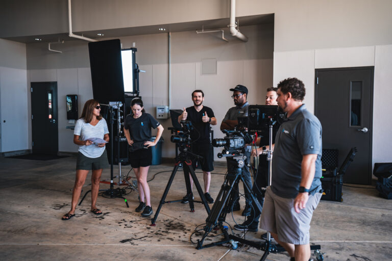 Several of the event videography staff filming a Legion event production